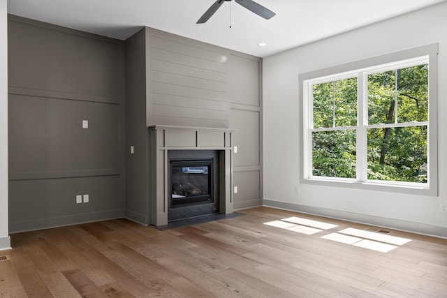 unfurnished living room featuring ceiling fan and light hardwood / wood-style floors