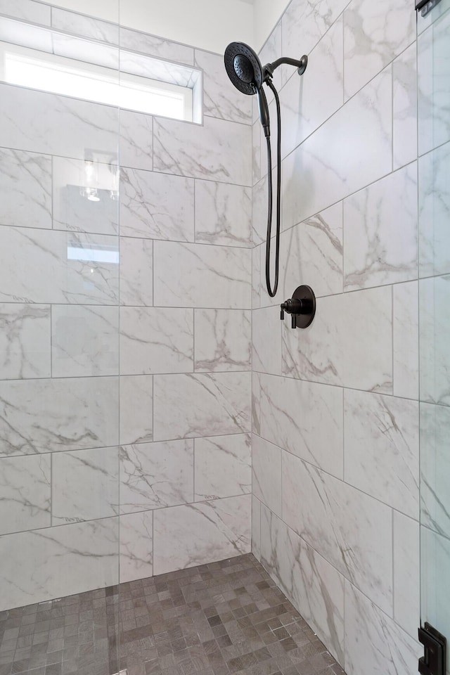 bathroom with a tile shower