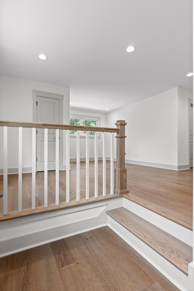 stairs with hardwood / wood-style flooring