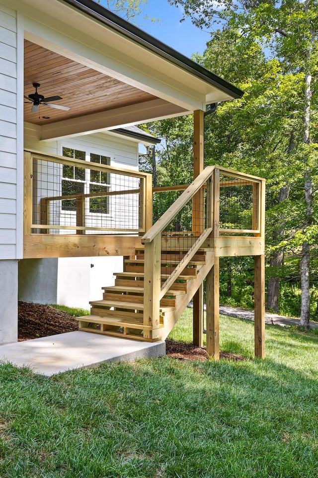 doorway to property featuring ceiling fan and a yard