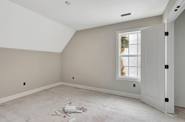 additional living space with baseboards and lofted ceiling
