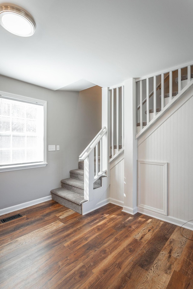 stairs with hardwood / wood-style flooring