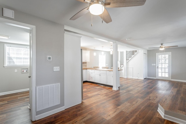 kitchen featuring white cabinets, dark wood-type flooring, and ceiling fan