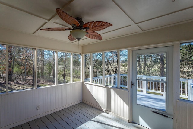 unfurnished sunroom featuring a wealth of natural light and ceiling fan