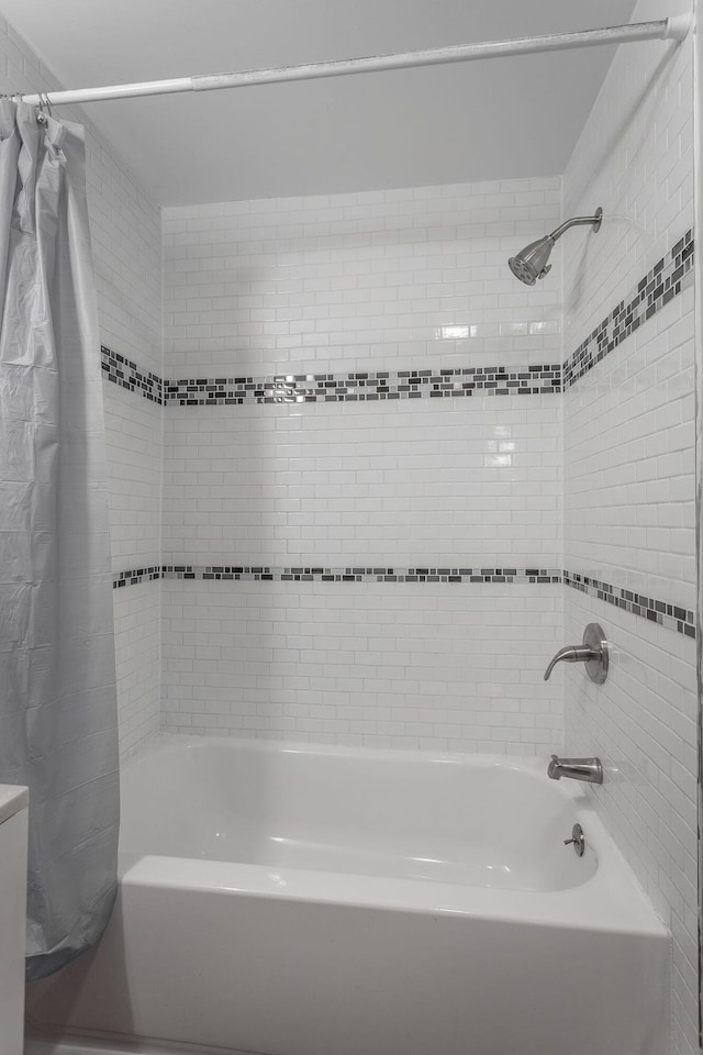 bathroom featuring shower / bathtub combination with curtain