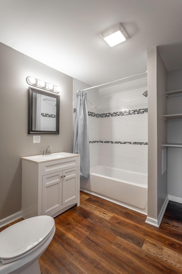 full bathroom featuring wood-type flooring, toilet, vanity, and shower / bath combo