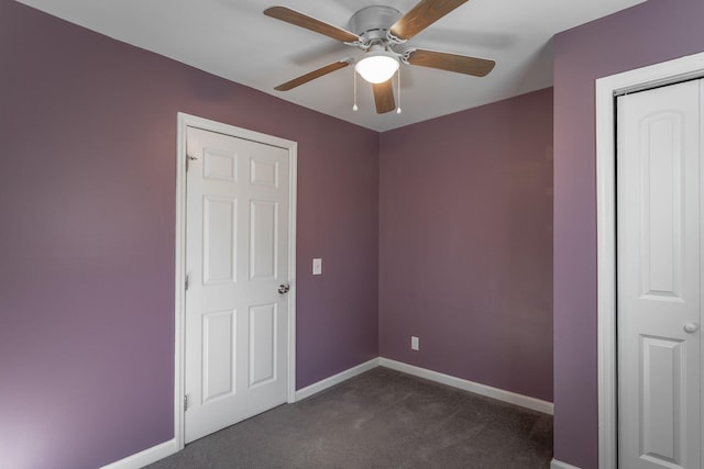 unfurnished bedroom featuring a closet, ceiling fan, and dark colored carpet