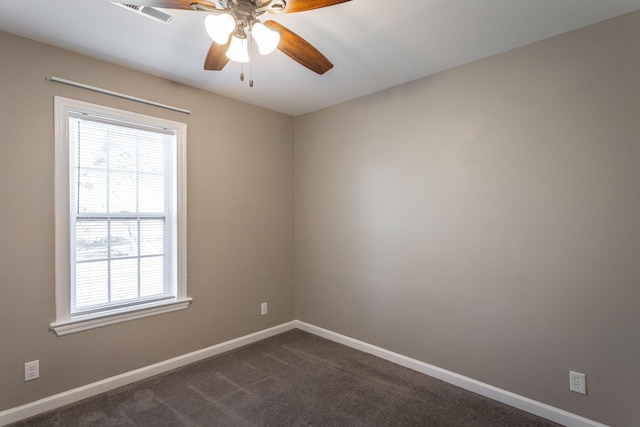 carpeted spare room featuring ceiling fan