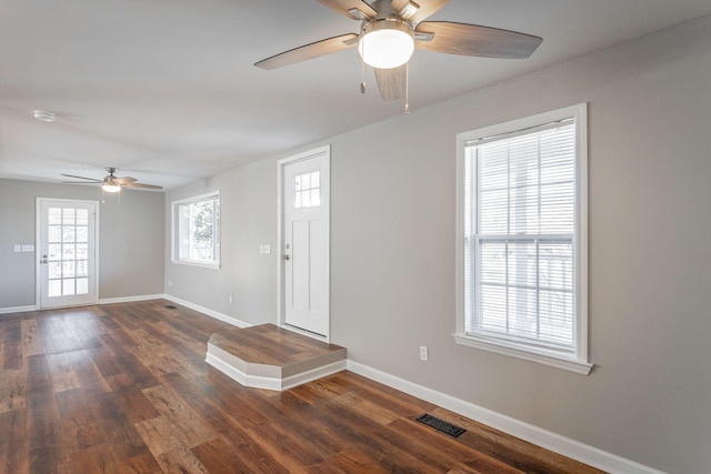 foyer entrance with ceiling fan, dark hardwood / wood-style floors, and plenty of natural light