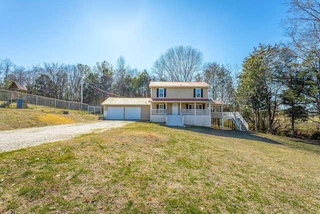 view of front of home with a porch, a garage, and a front lawn