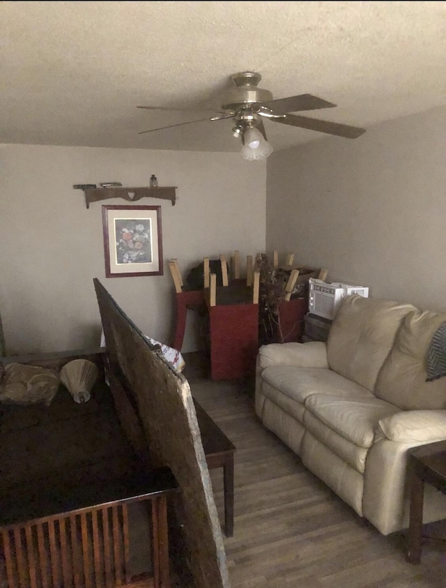 living room with ceiling fan and hardwood / wood-style flooring