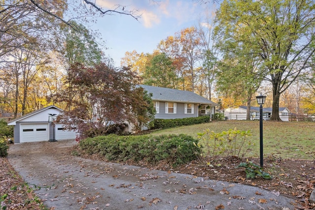 view of front of home with a garage and an outdoor structure