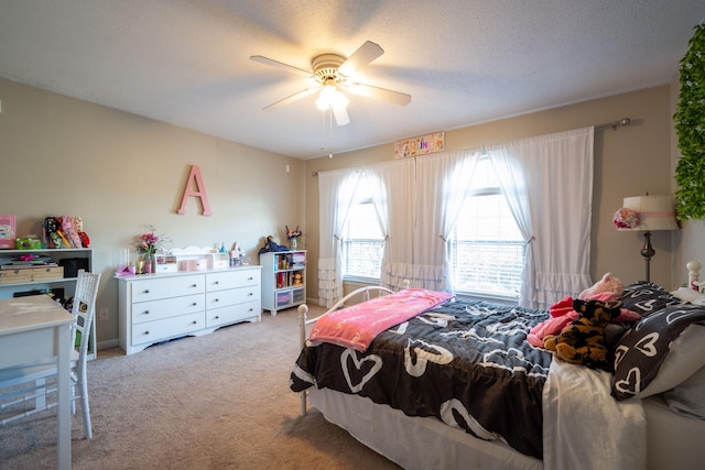 carpeted bedroom with ceiling fan and a textured ceiling