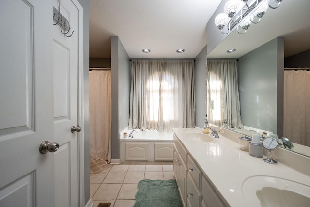 bathroom with a bathing tub, tile patterned floors, and vanity