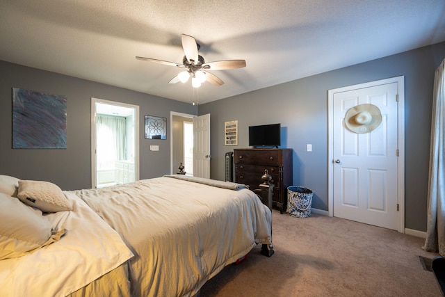 bedroom with ceiling fan, carpet flooring, and a textured ceiling