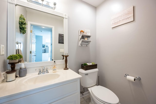 bathroom featuring vanity, toilet, and tile patterned floors