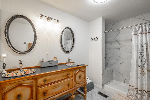 bathroom with vanity, a textured ceiling, and a shower with shower curtain