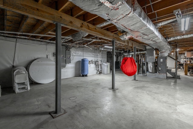 basement featuring heating unit and electric panel