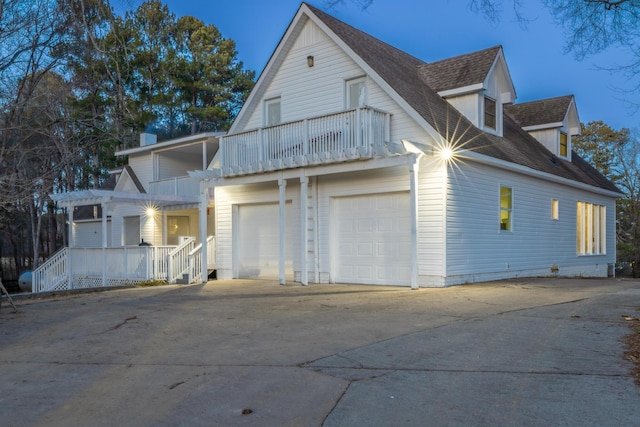 exterior space featuring a garage and a balcony