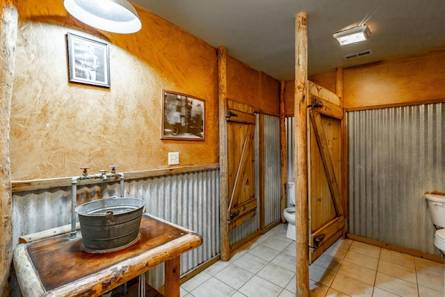 bathroom featuring tile patterned flooring and toilet