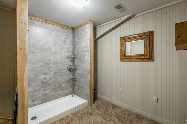 bathroom with a tile shower