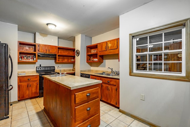 kitchen featuring light tile patterned flooring, sink, an island with sink, and black appliances