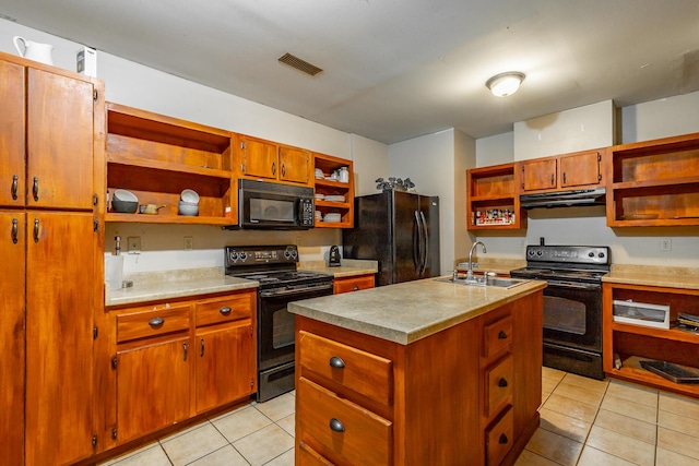 kitchen with light tile patterned flooring, sink, a center island with sink, and black appliances