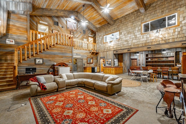 living room featuring beamed ceiling, wooden walls, high vaulted ceiling, and wooden ceiling