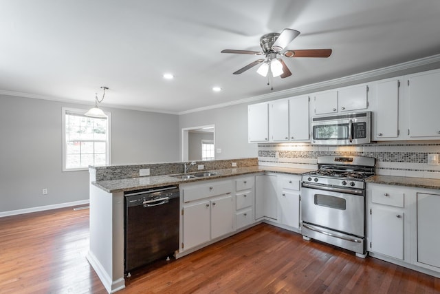 kitchen with white cabinetry, hanging light fixtures, appliances with stainless steel finishes, and ornamental molding