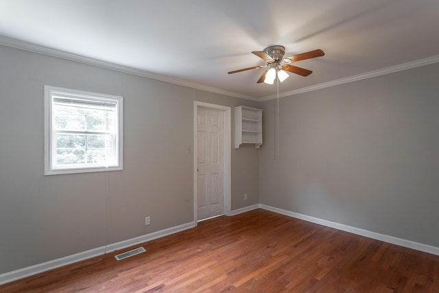 spare room with ceiling fan, hardwood / wood-style floors, and crown molding