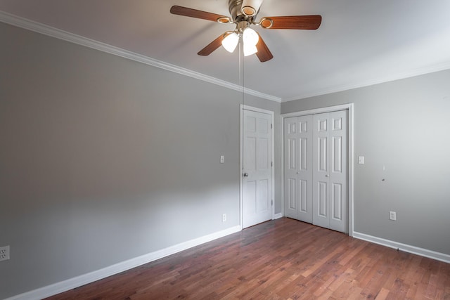 unfurnished bedroom with ceiling fan, dark hardwood / wood-style floors, and crown molding