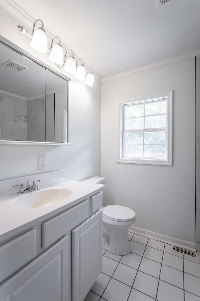 bathroom with vanity, toilet, ornamental molding, and tile patterned flooring