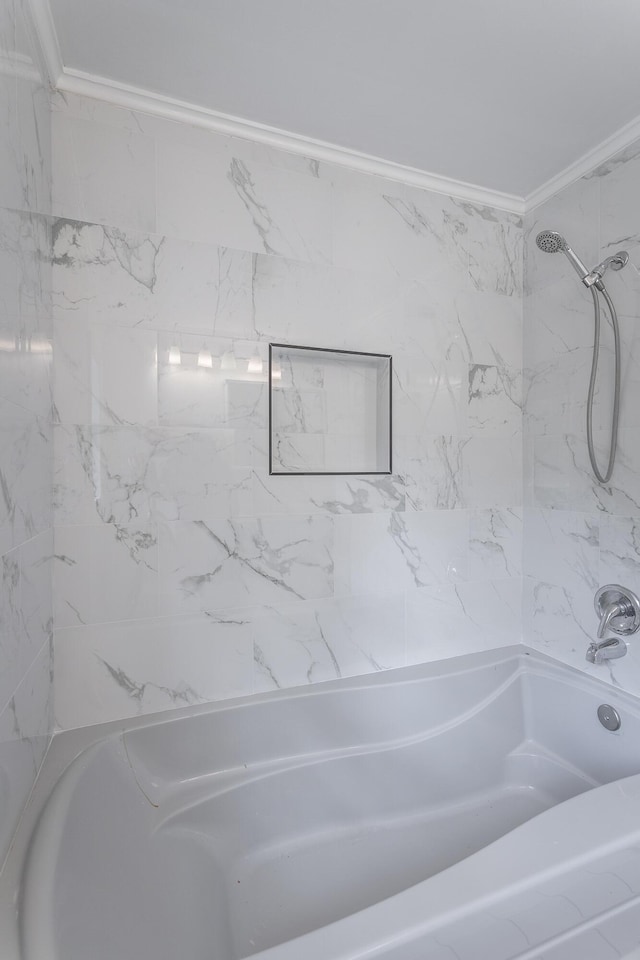 bathroom featuring ornamental molding and tiled shower / bath combo