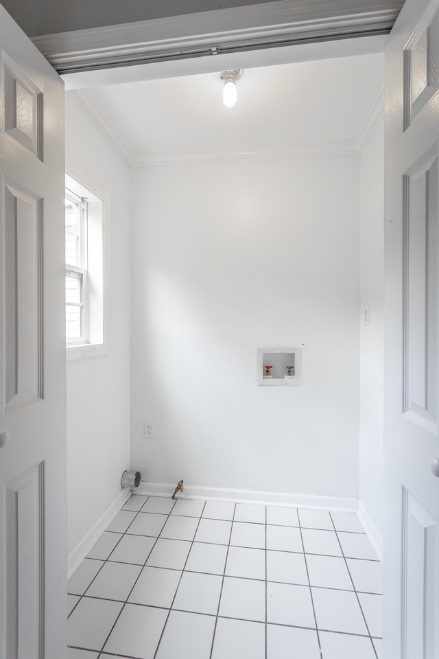 washroom featuring crown molding, hookup for a washing machine, and light tile patterned floors