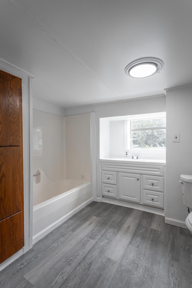 full bathroom with hardwood / wood-style flooring, sink, toilet, and shower / bathing tub combination