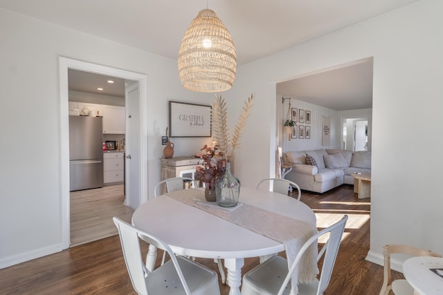 dining area featuring a chandelier and dark wood-type flooring