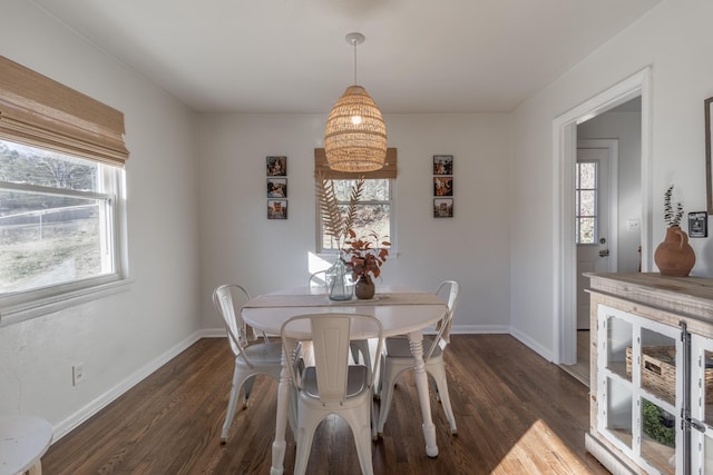 dining area with dark wood-type flooring