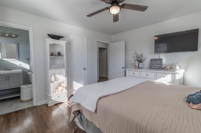 bedroom with ensuite bath, dark hardwood / wood-style flooring, sink, a closet, and ceiling fan