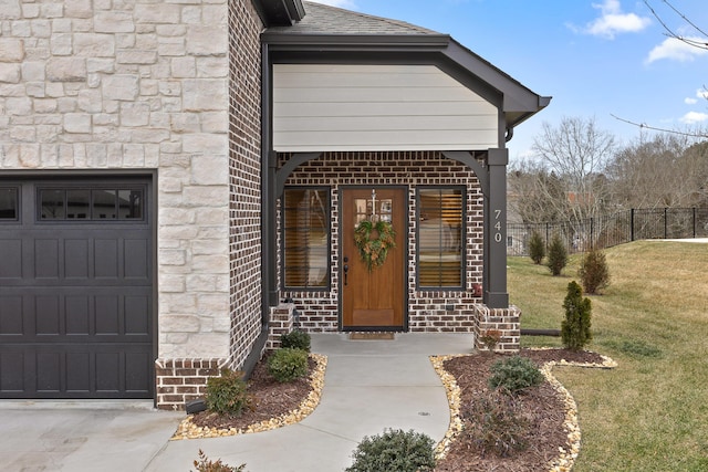 property entrance with a garage, a lawn, and covered porch