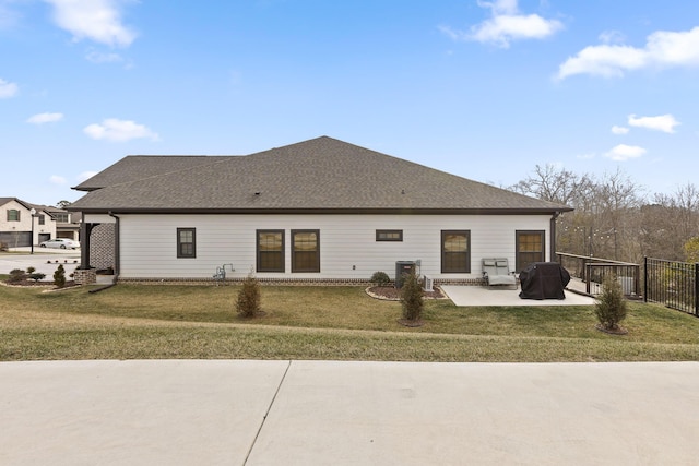 rear view of property with a yard and a patio area