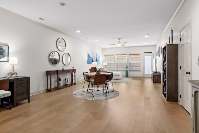 dining room with crown molding, light hardwood / wood-style flooring, and ceiling fan