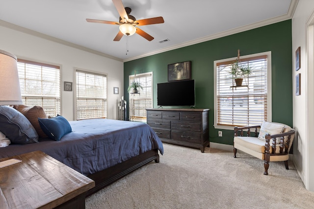 carpeted bedroom with ceiling fan, ornamental molding, and multiple windows