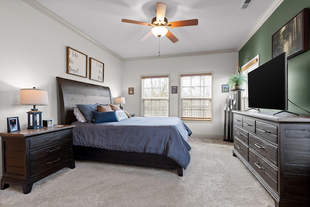 bedroom with ornamental molding, light colored carpet, and ceiling fan