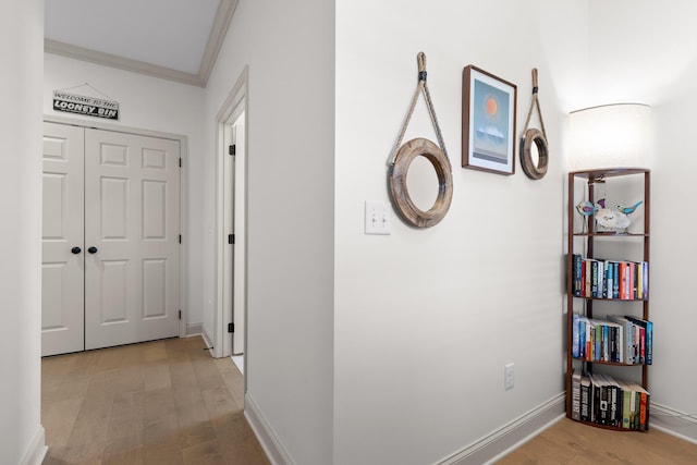 hall featuring ornamental molding and light wood-type flooring