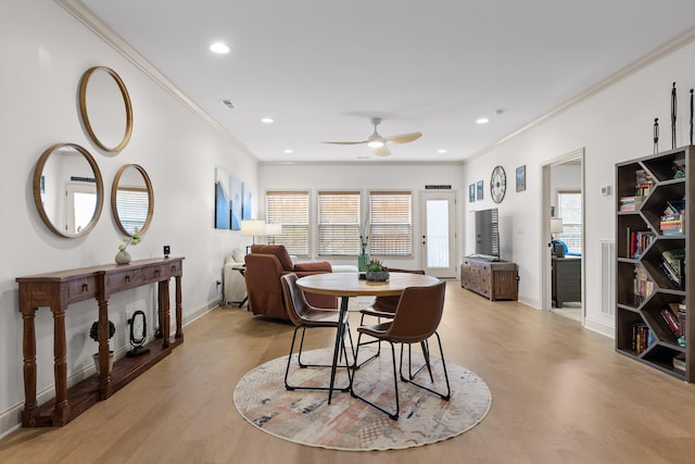 dining space with crown molding, ceiling fan, and light hardwood / wood-style floors