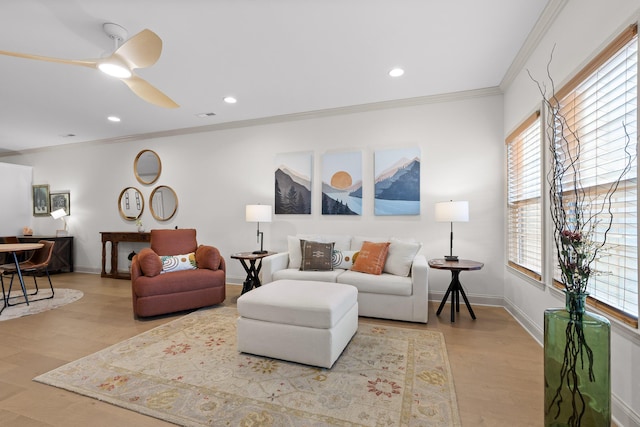 living room featuring crown molding, ceiling fan, and light hardwood / wood-style flooring