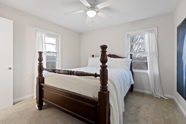 carpeted bedroom with multiple windows and ceiling fan