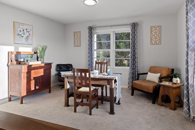 dining space featuring light colored carpet