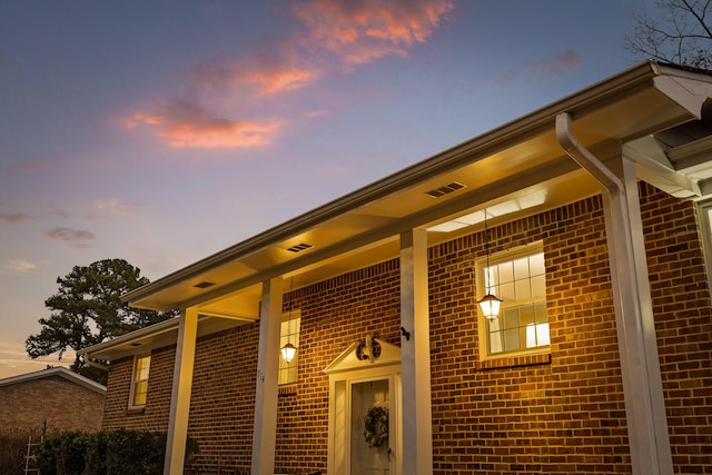 view of exterior entry at dusk