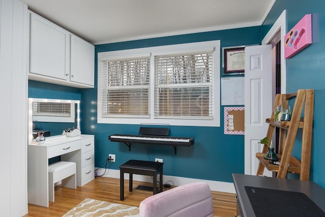 miscellaneous room with light hardwood / wood-style floors and ornamental molding